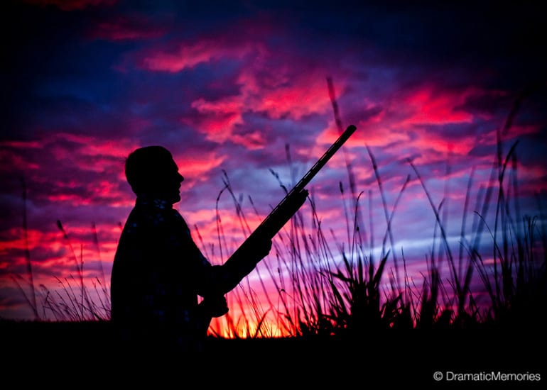 silhouette of a hunter outdoors with a beautiful sunset