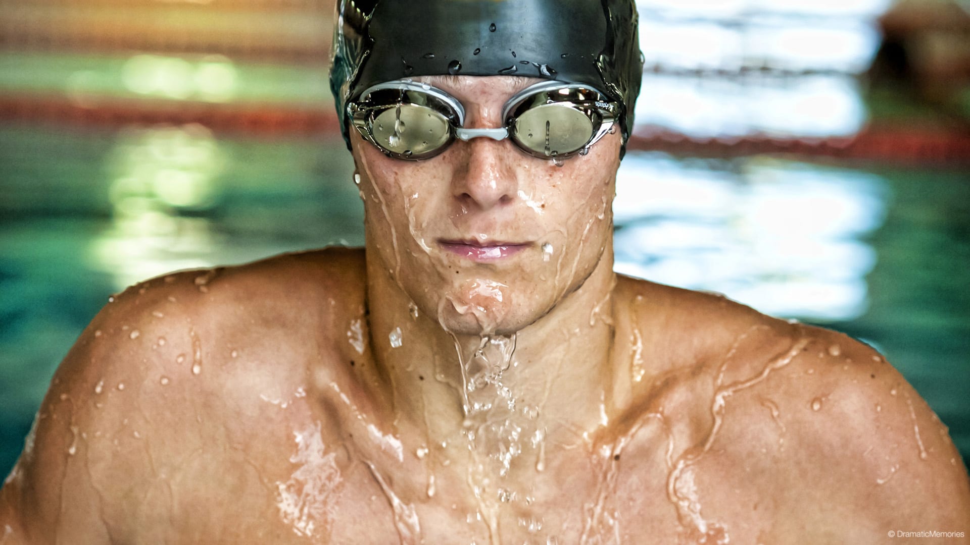 swimmer in goggles coming out of water