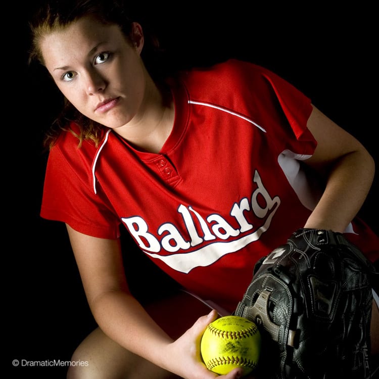 Sports Senior Pictures Girl Softball Pitcher with Dramatic Lighting