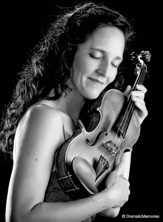 black and white image of a musician caressing her violin
